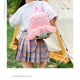 Girl wearing Sanrio My Melody plush backpack, pink and cute, perfect for students or leisure use, in a casual outdoor setting.